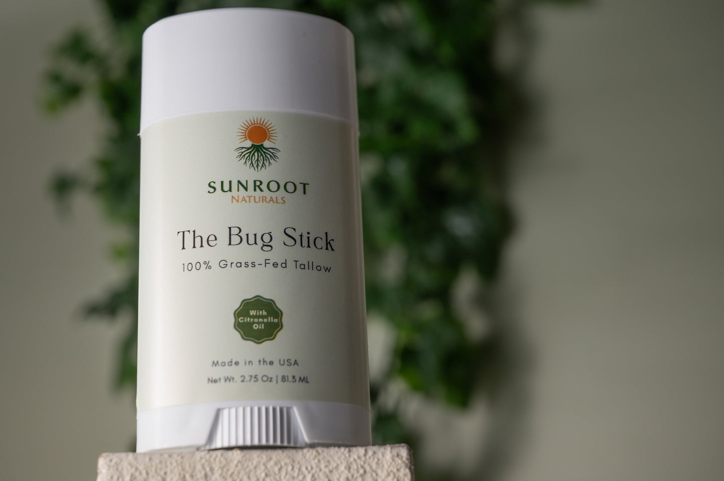 Sunroot The Bug Stick insect repellent displayed in a minimalist flat lay arrangement.