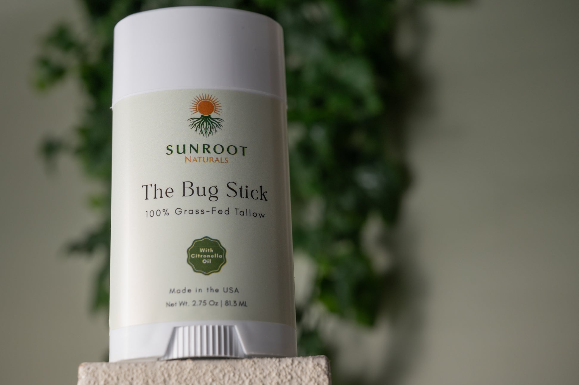 Sunroot The Bug Stick insect repellent displayed in a minimalist flat lay arrangement.